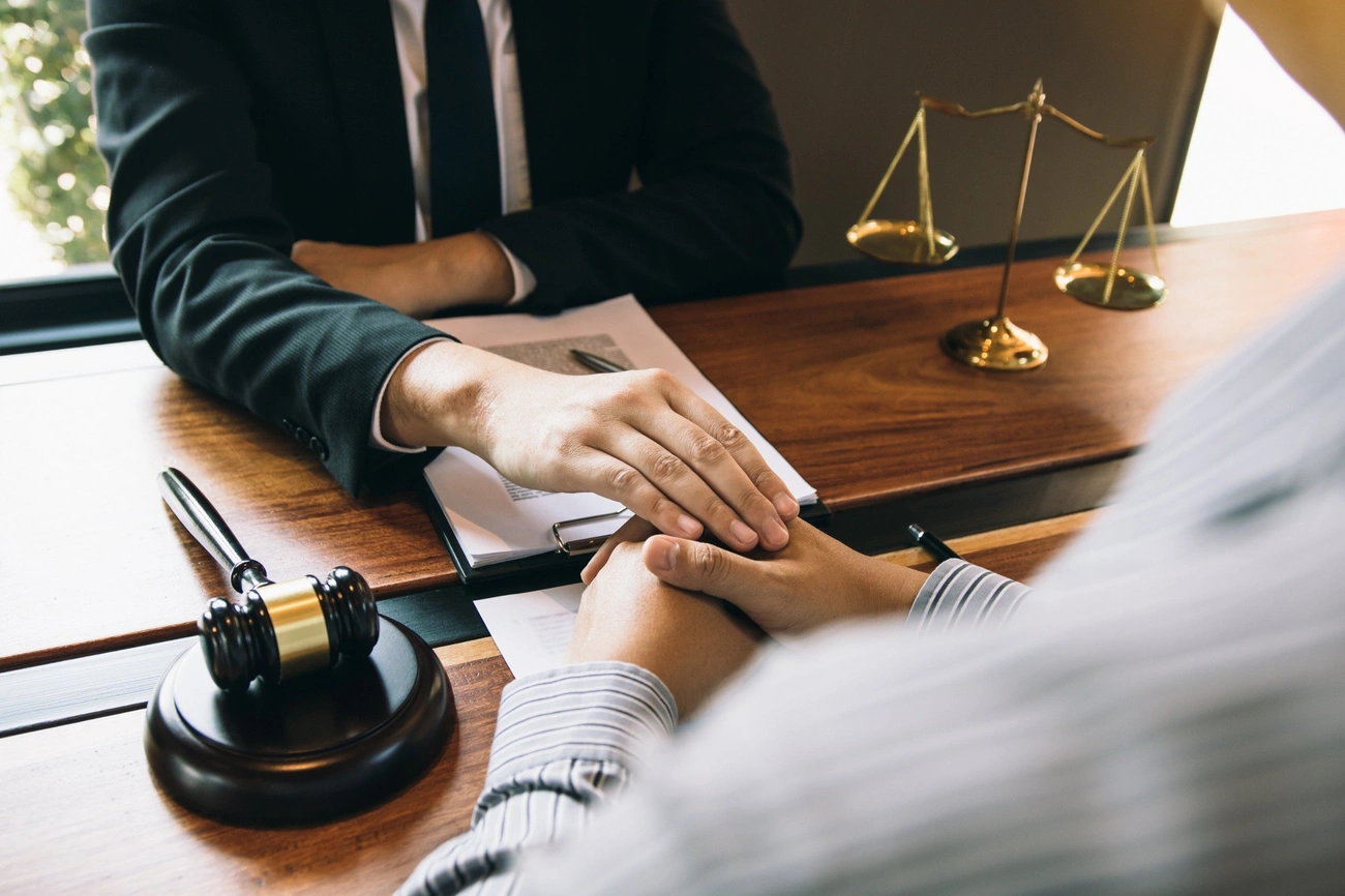 An injury attorney discussing a personal injury case with a client to secure fair compensation.